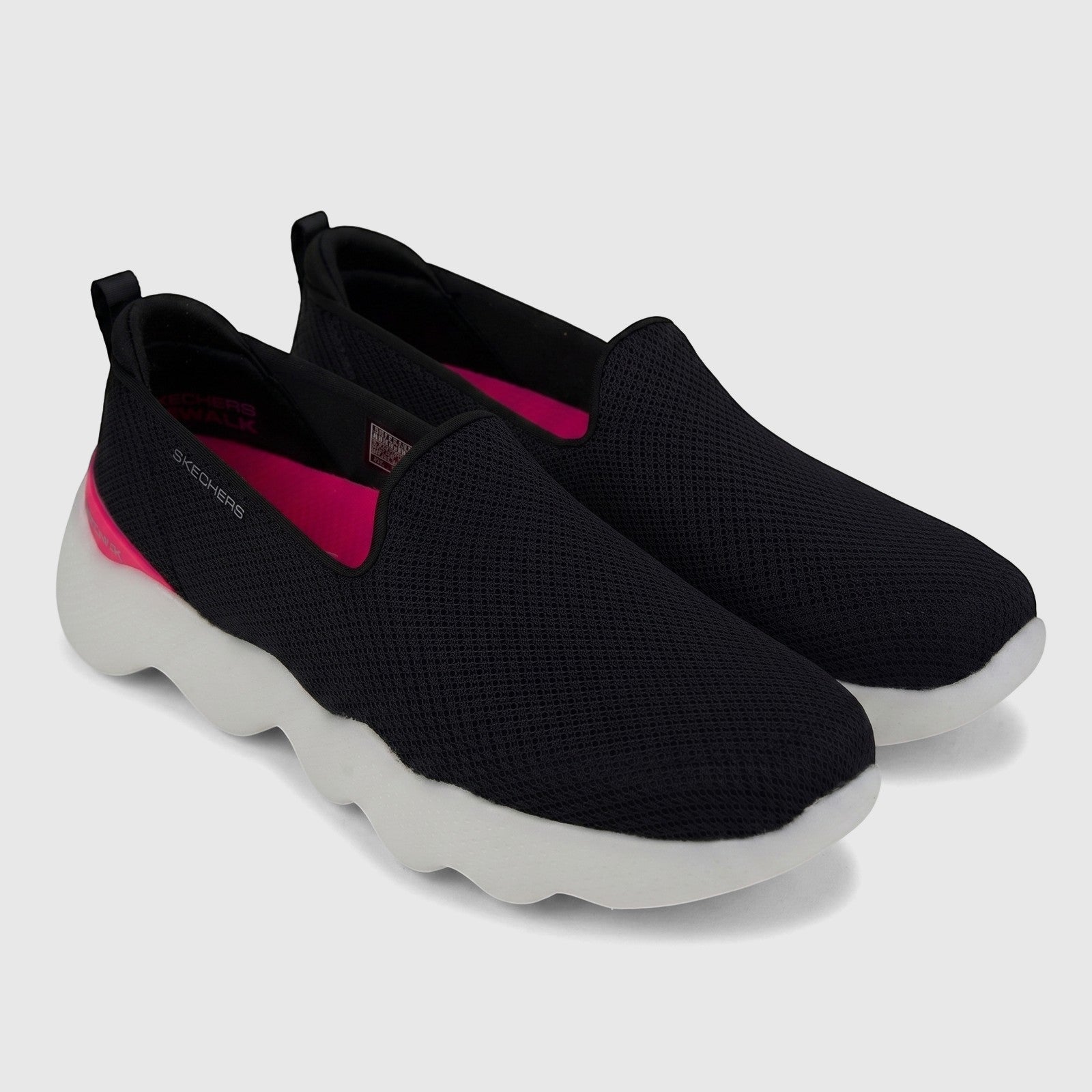 A pair of Skechers Ladies Comfort Slip On Sneakers Go Walk Massage Fit 124908 in black mesh with hot pink accents, shown