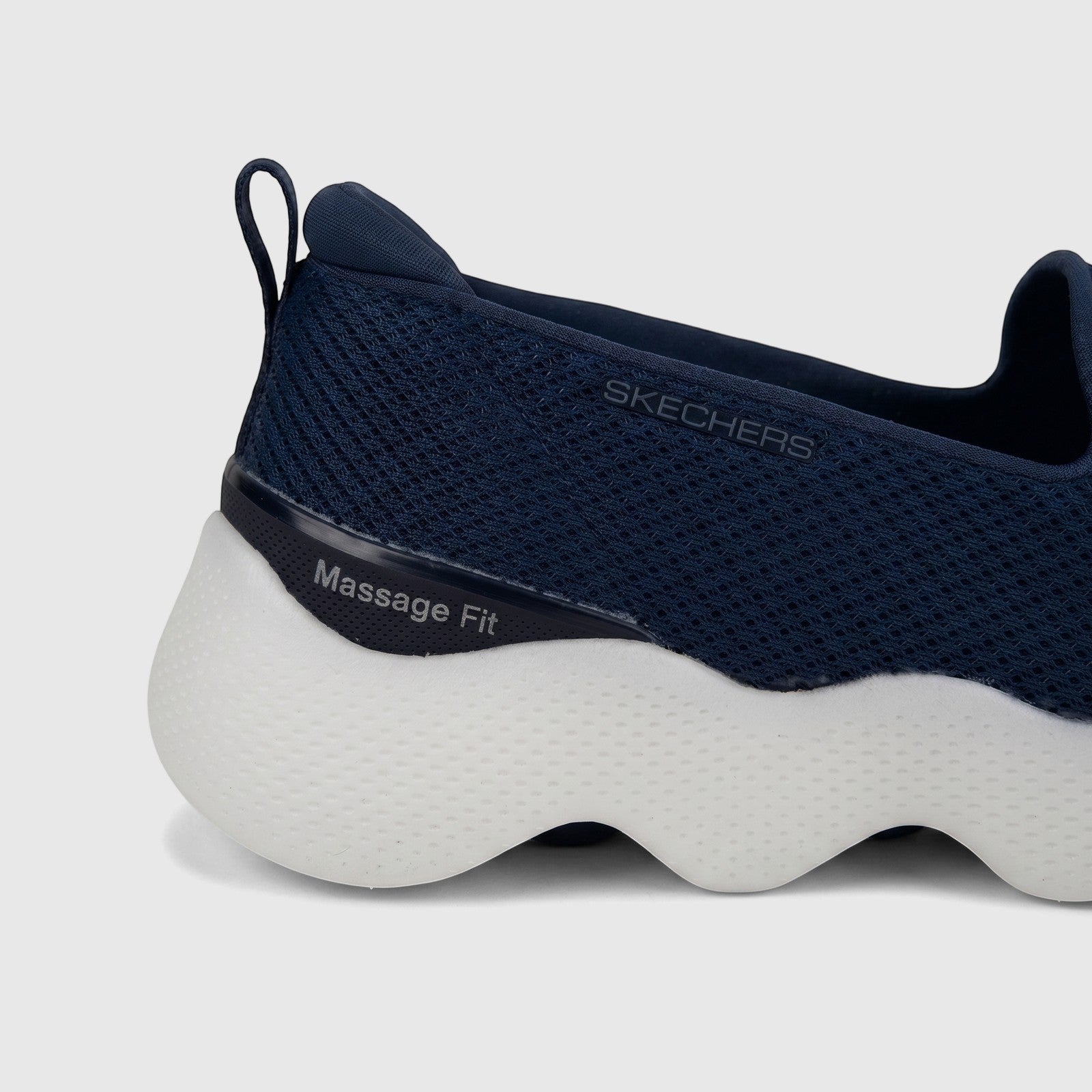 Close-up view of a navy blue Skechers Ladies Comfort Slip On Sneaker Go Walk Massage Fit with a white wavy sole.