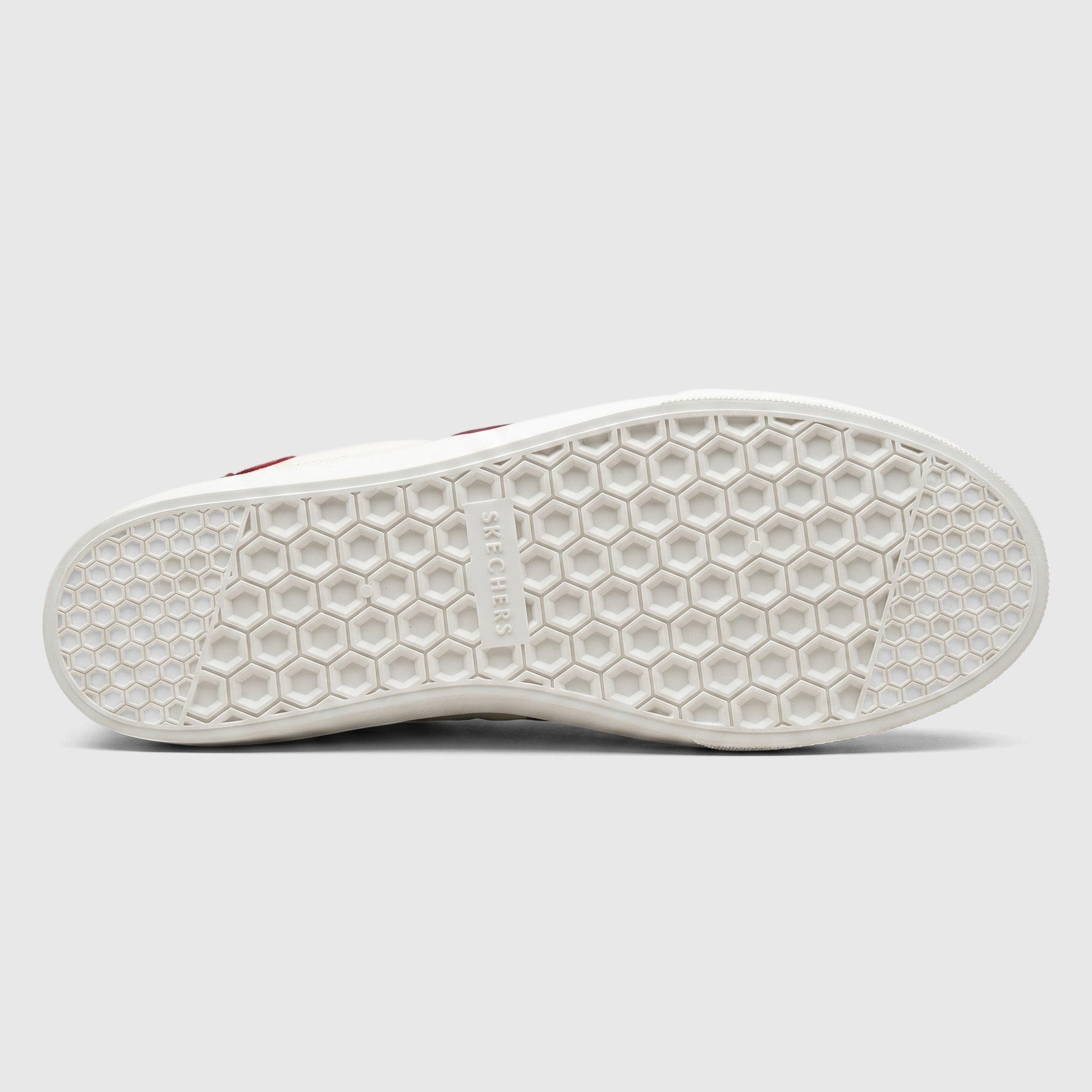White Skechers Ladies Comfort Slip On Sneaker Poppy, bottom view, showing the hexagonal tread pattern sole and brand logo.