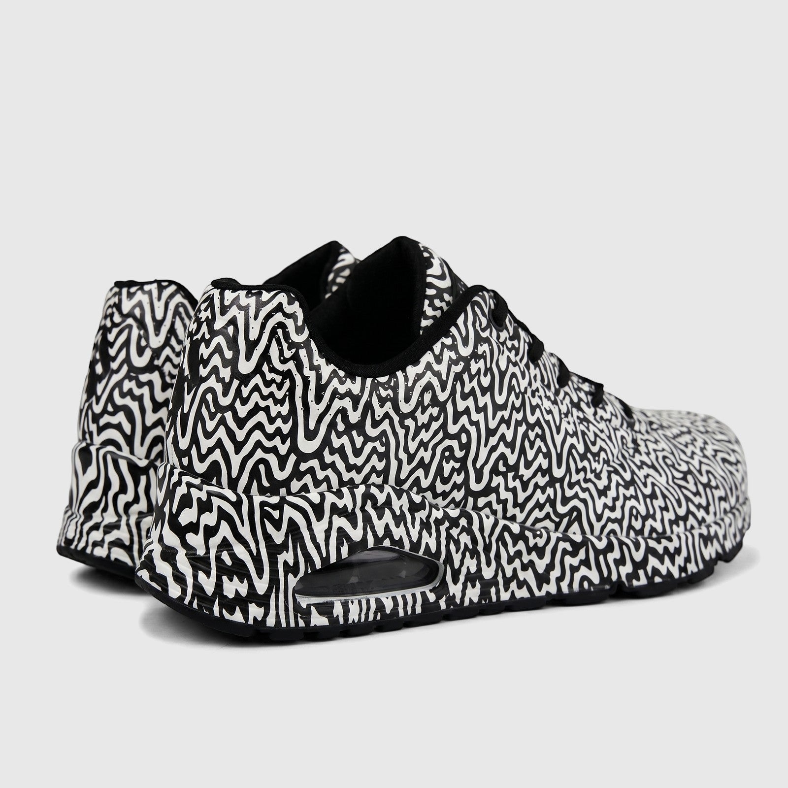Skechers Ladies Sneaker Comfort Sneaker Uno 177960 sneakers in black and white wavy pattern, showing side-rear view.