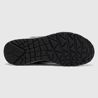 Bottom view of a black Skechers Uno Comfort Sneaker, highlighting the durable rubber outsole with geometric tread patterns.