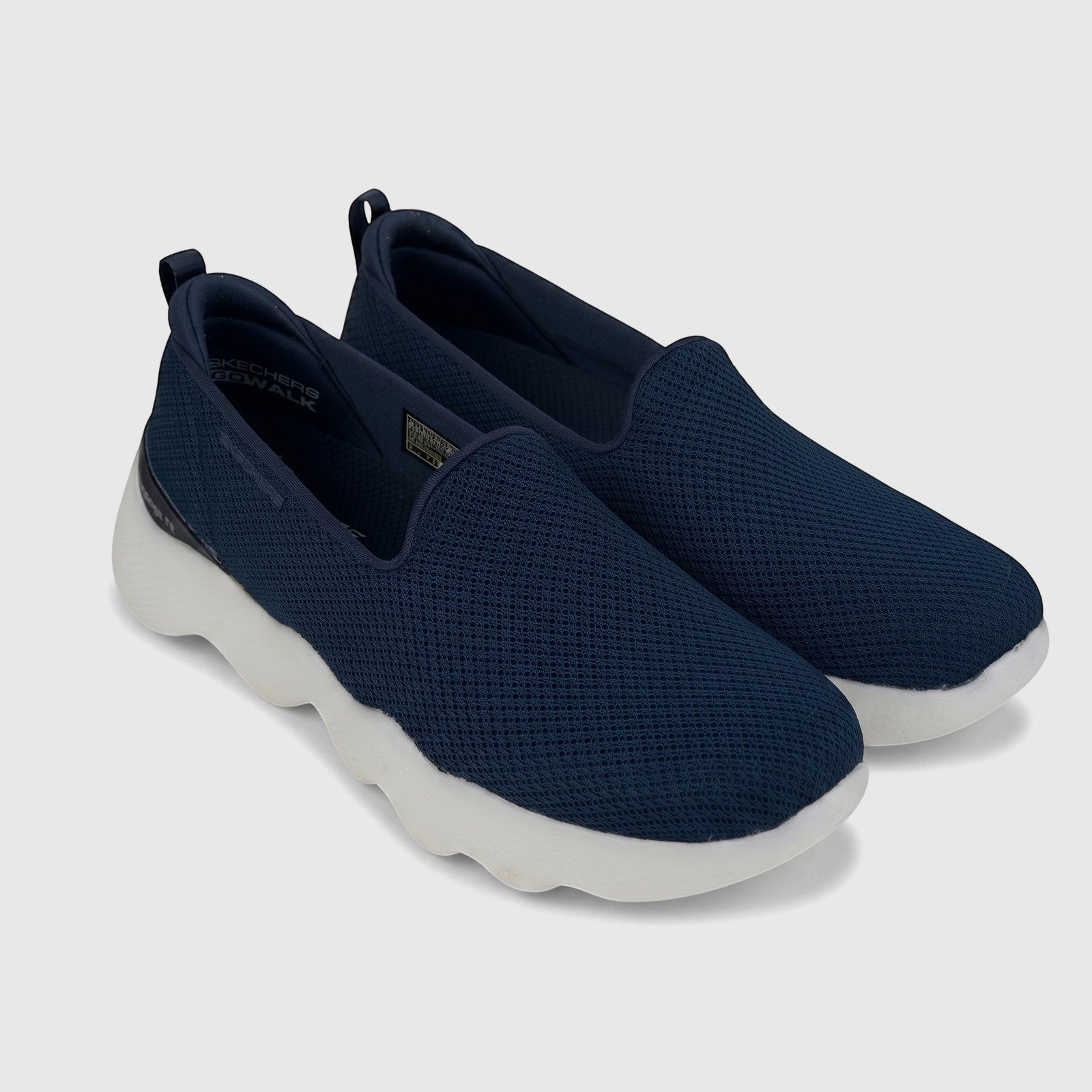 Navy blue Skechers Go Walk Massage Fit slip-on sneakers for ladies, with a breathable mesh upper and chunky white sole,