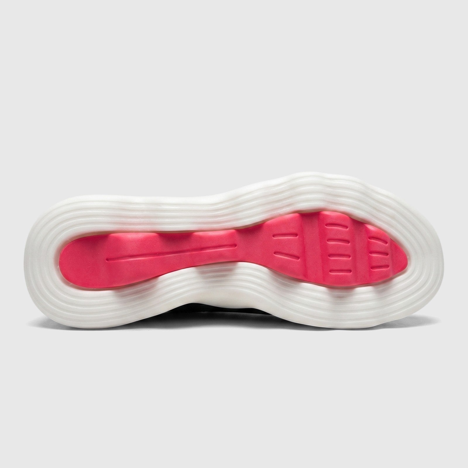 Bottom view of a Skechers Go Walk Massage Fit sneaker sole, featuring a white wavy outsole and a vibrant hot pink insert.