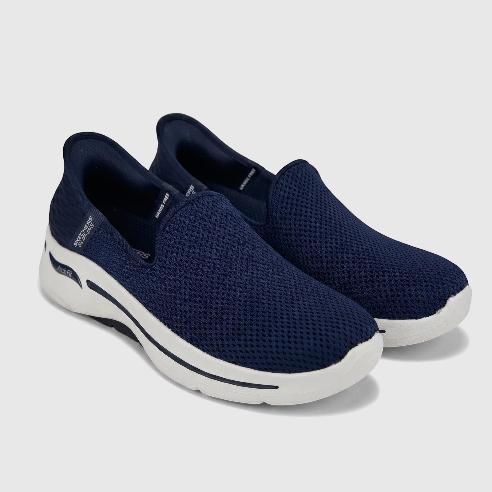 Navy blue Skechers Slip-ins Comfort Arch Fit sneakers for ladies, shown in a three-quarter view.