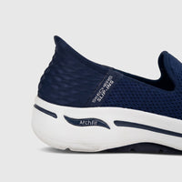 Close-up of a navy blue Skechers Ladies Slip Ins Comfort Sneaker Go Walk Arch Fit shoe with a white sole on a plain