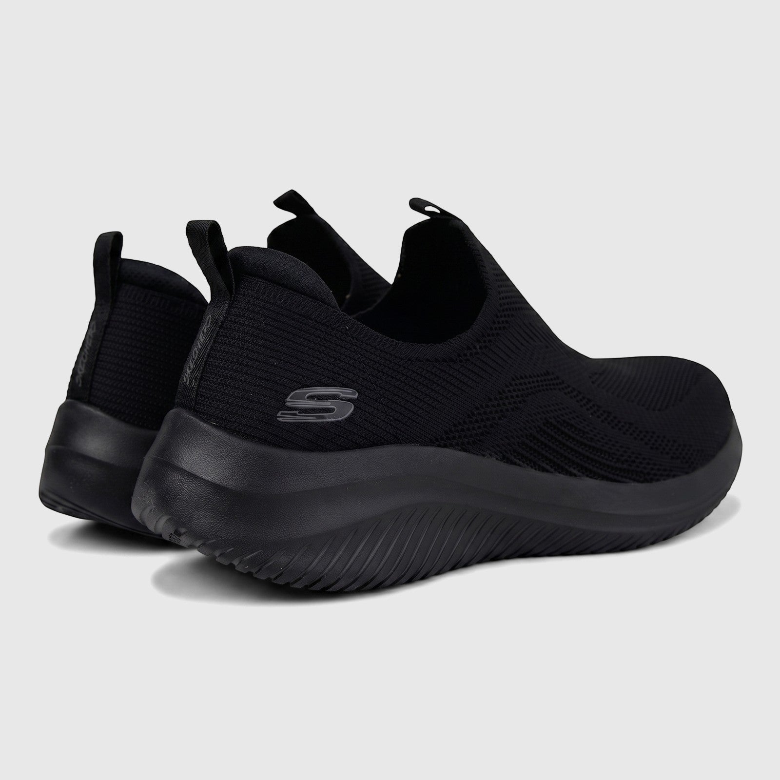 Black Skechers Ultra Flex 3.0 slip-on sneakers for ladies, featuring a comfortable knit upper and chunky sole, viewed from