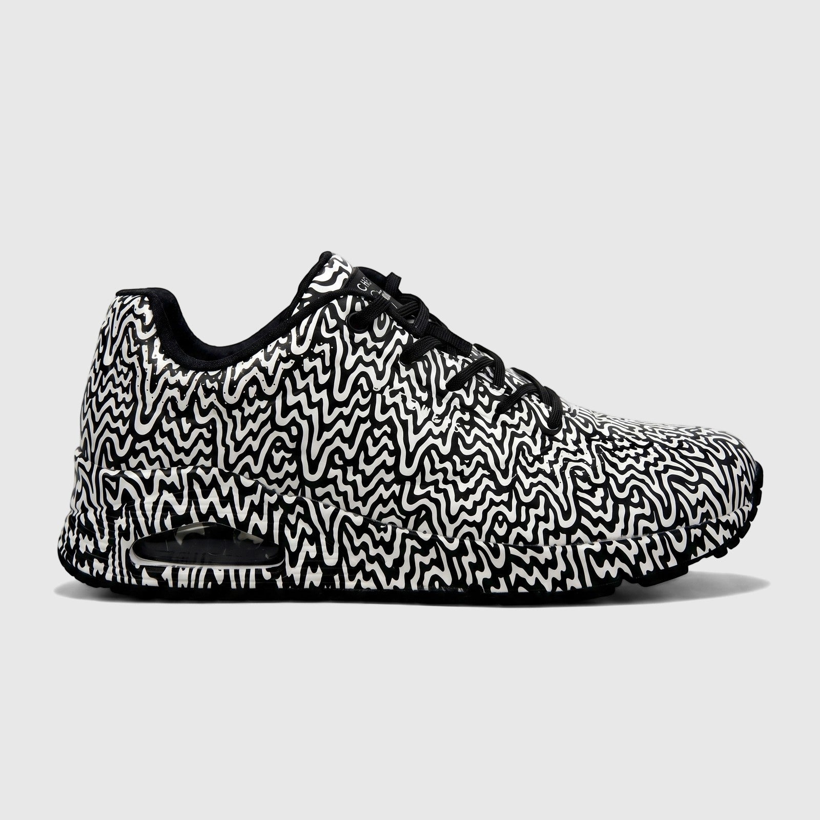 Skechers Ladies Uno 177960 comfort sneaker in black and white with an abstract swirly pattern, side profile view.