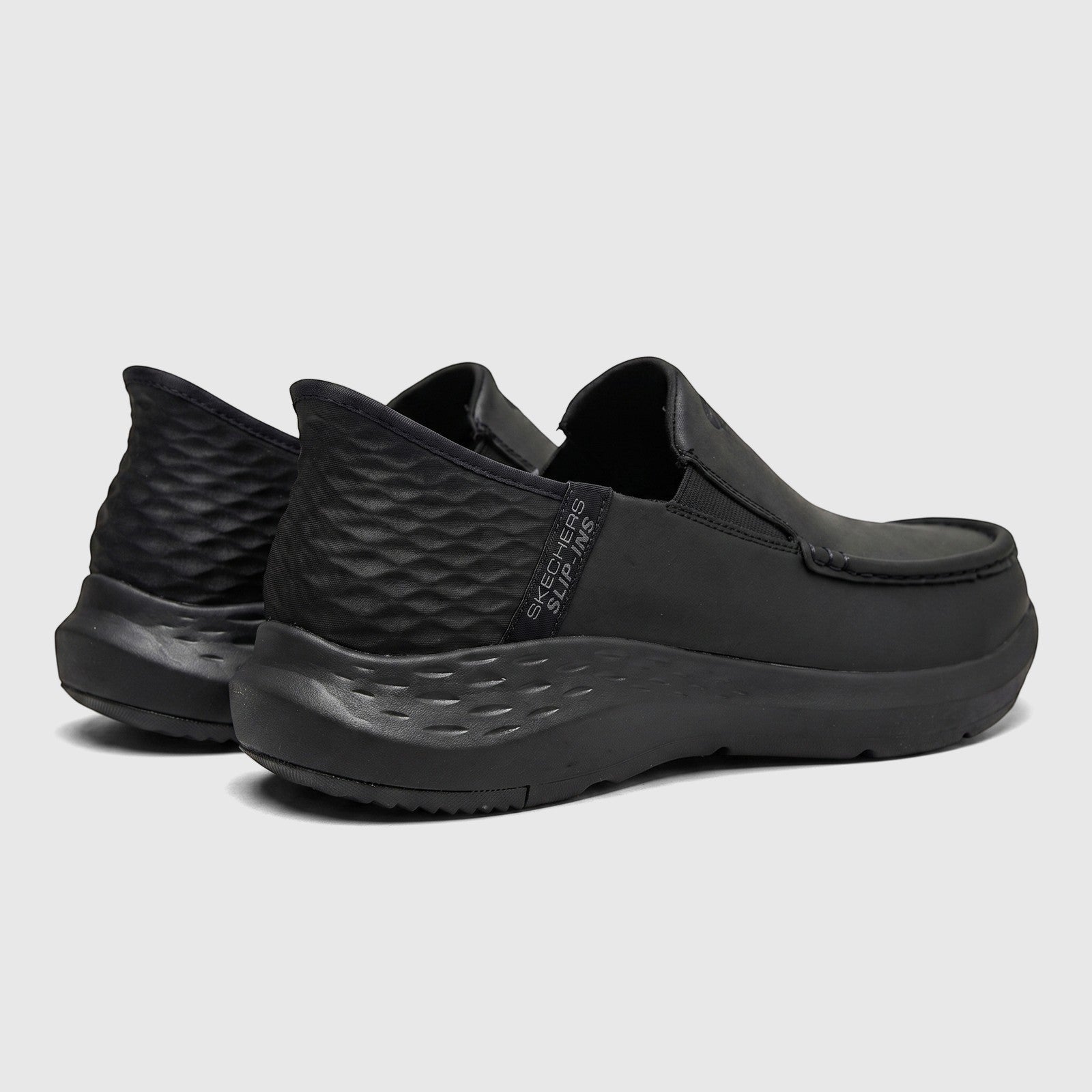 Rear three-quarter view of Skechers Men's Comfort Casual Slip-Ins Parson 204866 in black, showcasing the design and textured