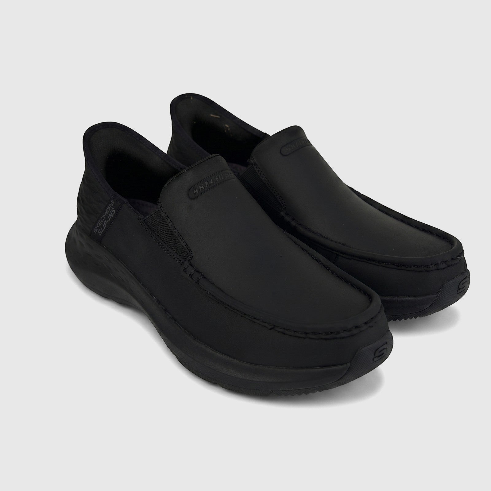 Skechers Men's Comfort Casual Slip-Ins Parson black shoes, offering easy wear and a stylish, versatile design.