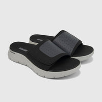 Pair of Skechers Men's Comfort Slide Go Walk Flex Sandals in black with a light gray sole and perforated strap, photographed