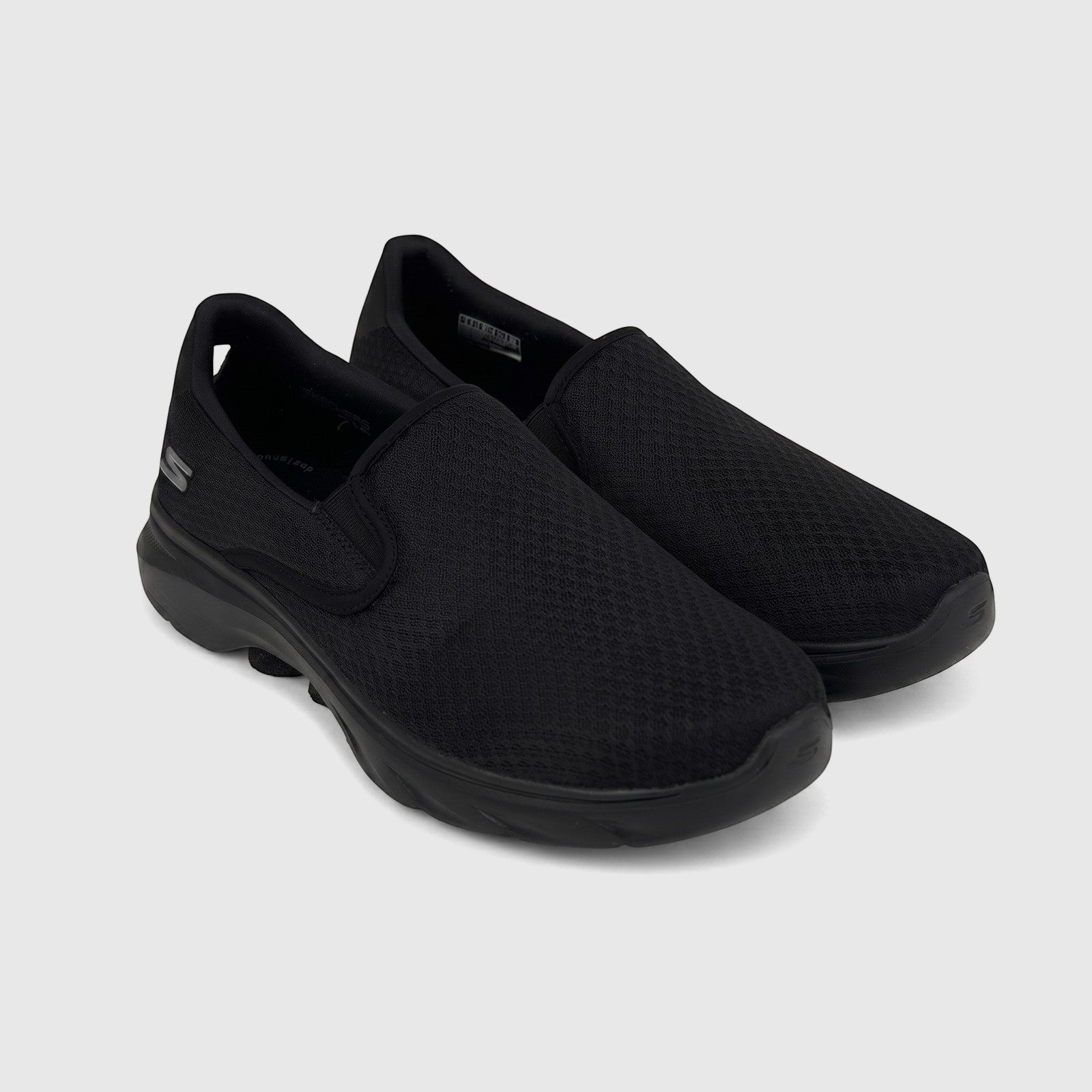 Pair of black Skechers Men's Comfort Slip On Go Walk 7 sneakers with a mesh upper, displayed at an angle.