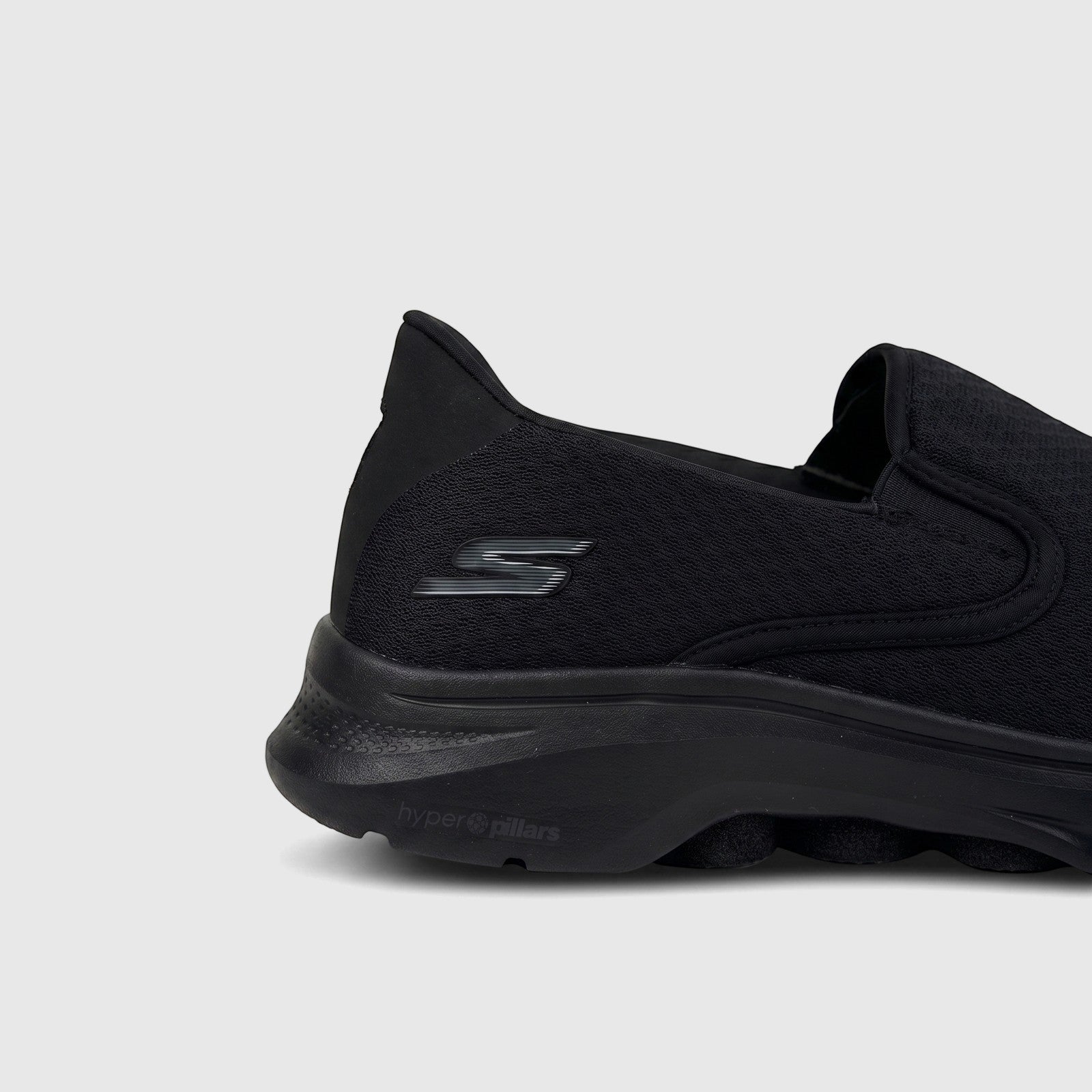 Side view of a black Skechers Men's Comfort Slip On Sneaker Go Walk 7 216646. Features a mesh upper and 'hyper pillars' sole.