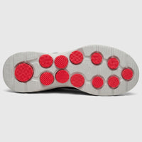 Bottom view of a Skechers Men's Comfort Slip On Sneaker Go Walk 7 in charcoal black, showing the grey sole with round red