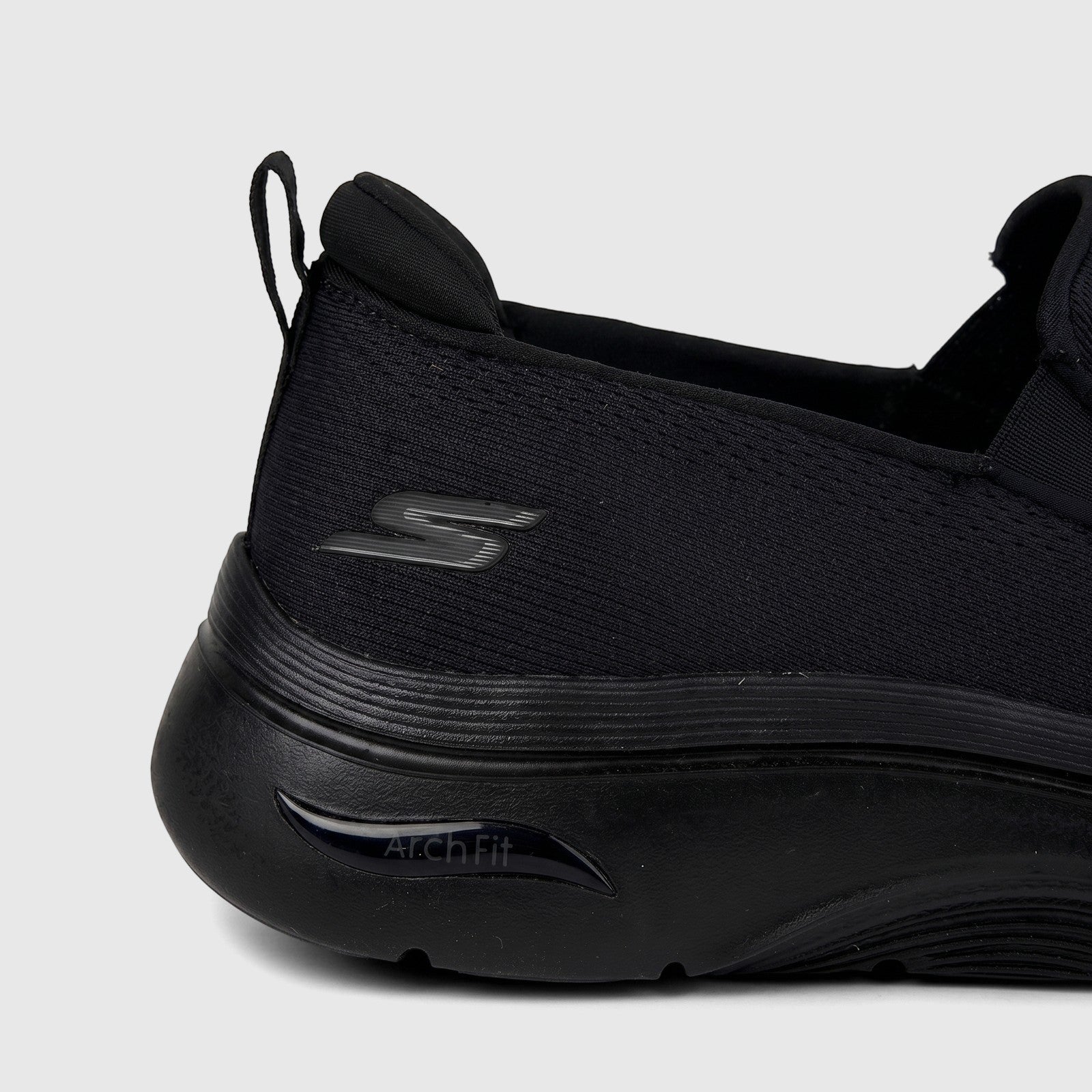 Close-up of the black Skechers Men's Comfort Slip On Sneaker Go Walk Arch Fit 2.0, showing the heel and Arch Fit branding.