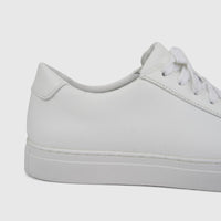 A close-up side view of a white leather Skechers Men's Comfort Sneaker Arch Fit Legend with white laces.