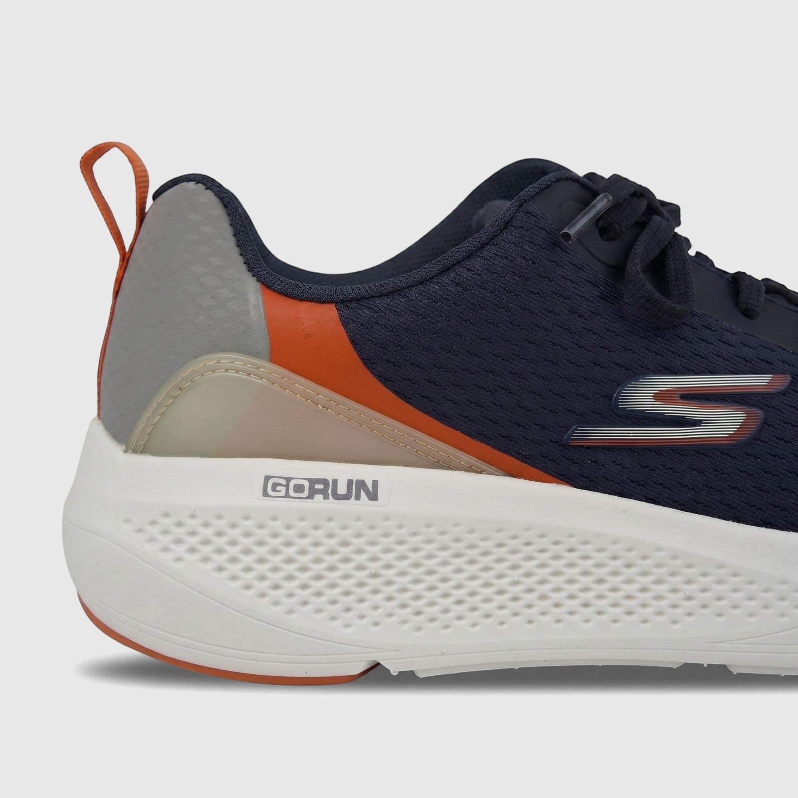 Close-up side view of a Skechers Men's Comfort Sneaker Go Run Elevate 220189 in navy blue and orange with a white sole.