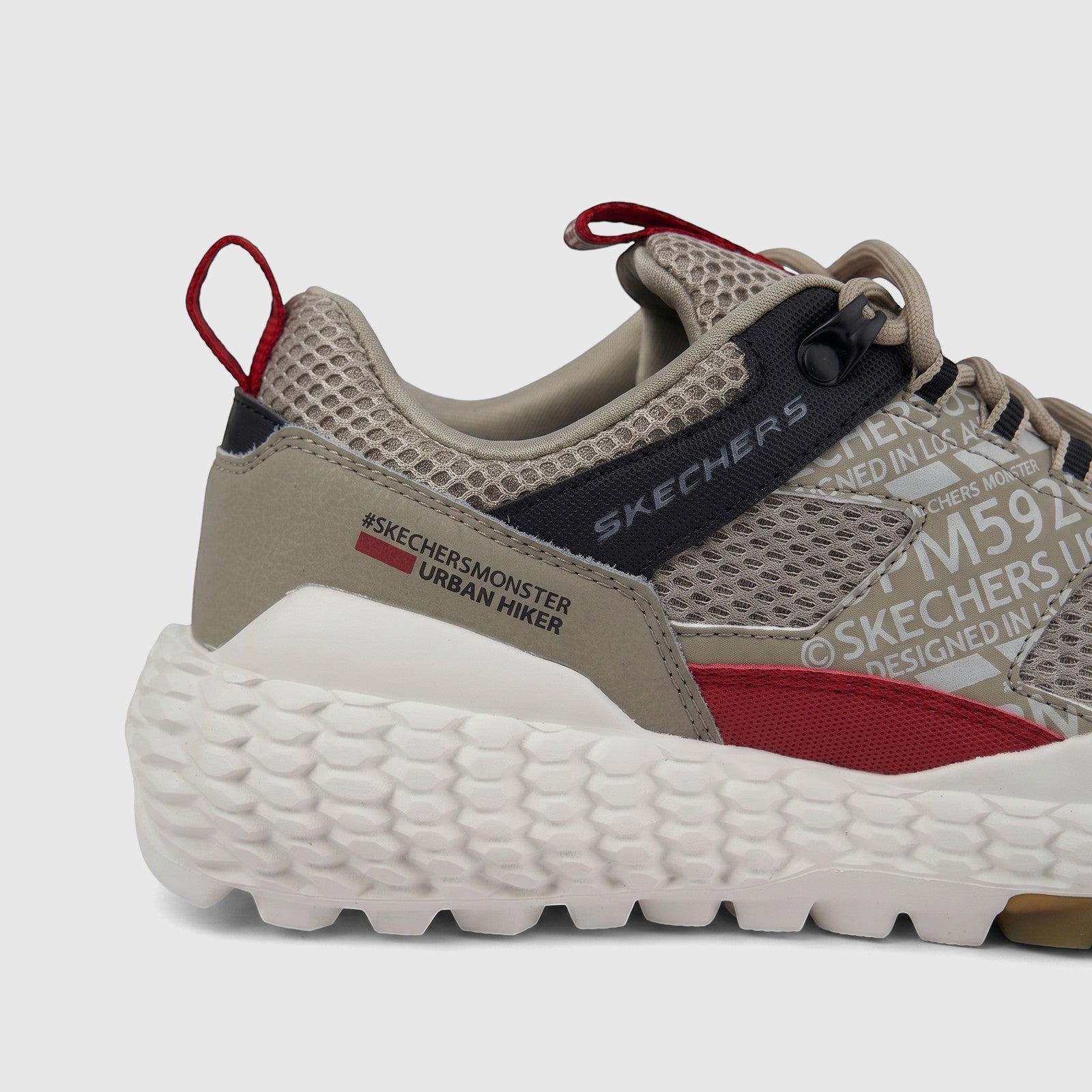 Close-up side view of a Skechers Men's Comfort Sneaker Monster Mashton 232189. This taupe multi-colored urban hiker shoe