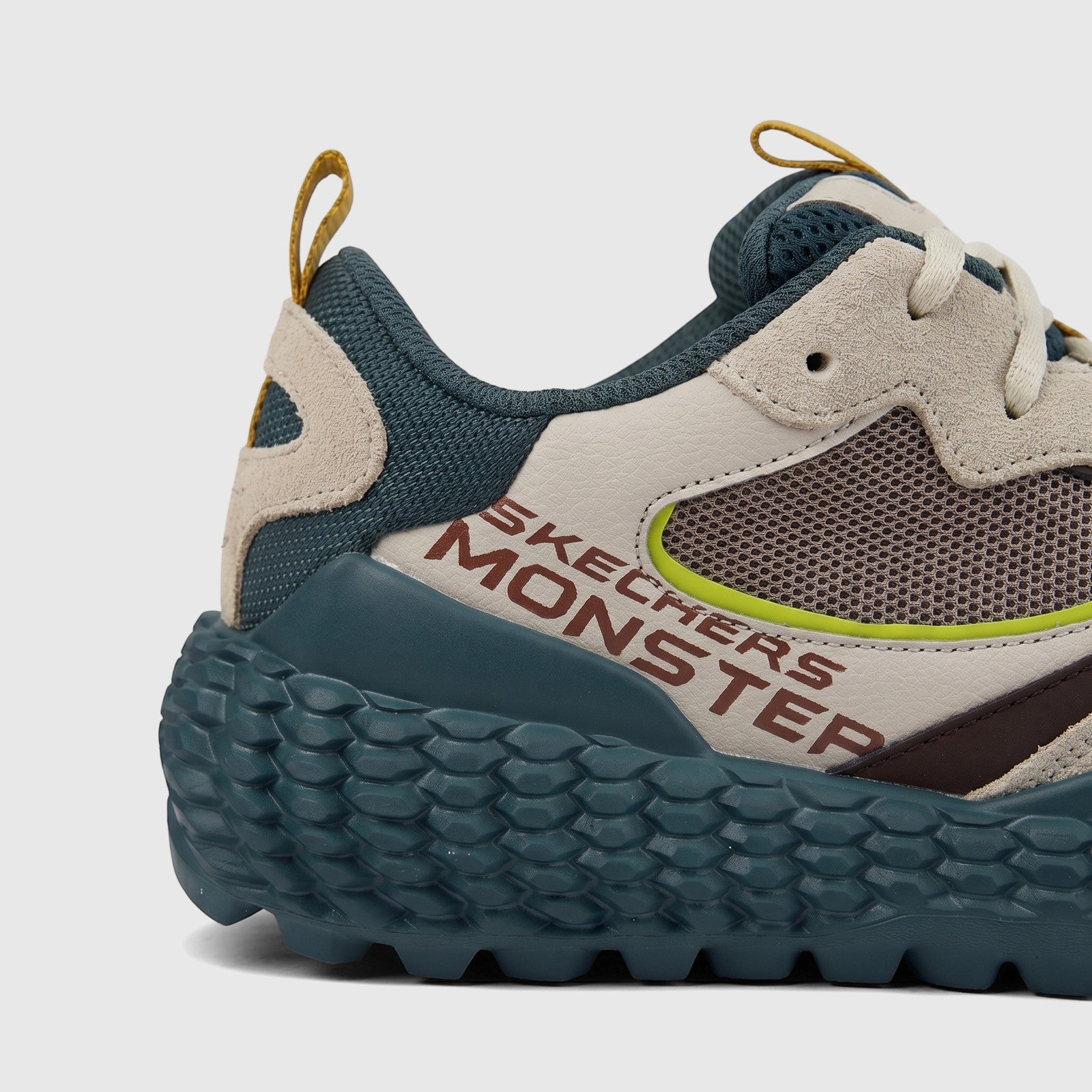 Skechers Men's Comfort Sneaker in taupe and olive green with a textured sole, featuring 'Skechers Monster' branding, viewed