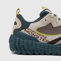 Skechers Men's Comfort Sneaker in taupe and olive green with a textured sole, featuring 'Skechers Monster' branding, viewed