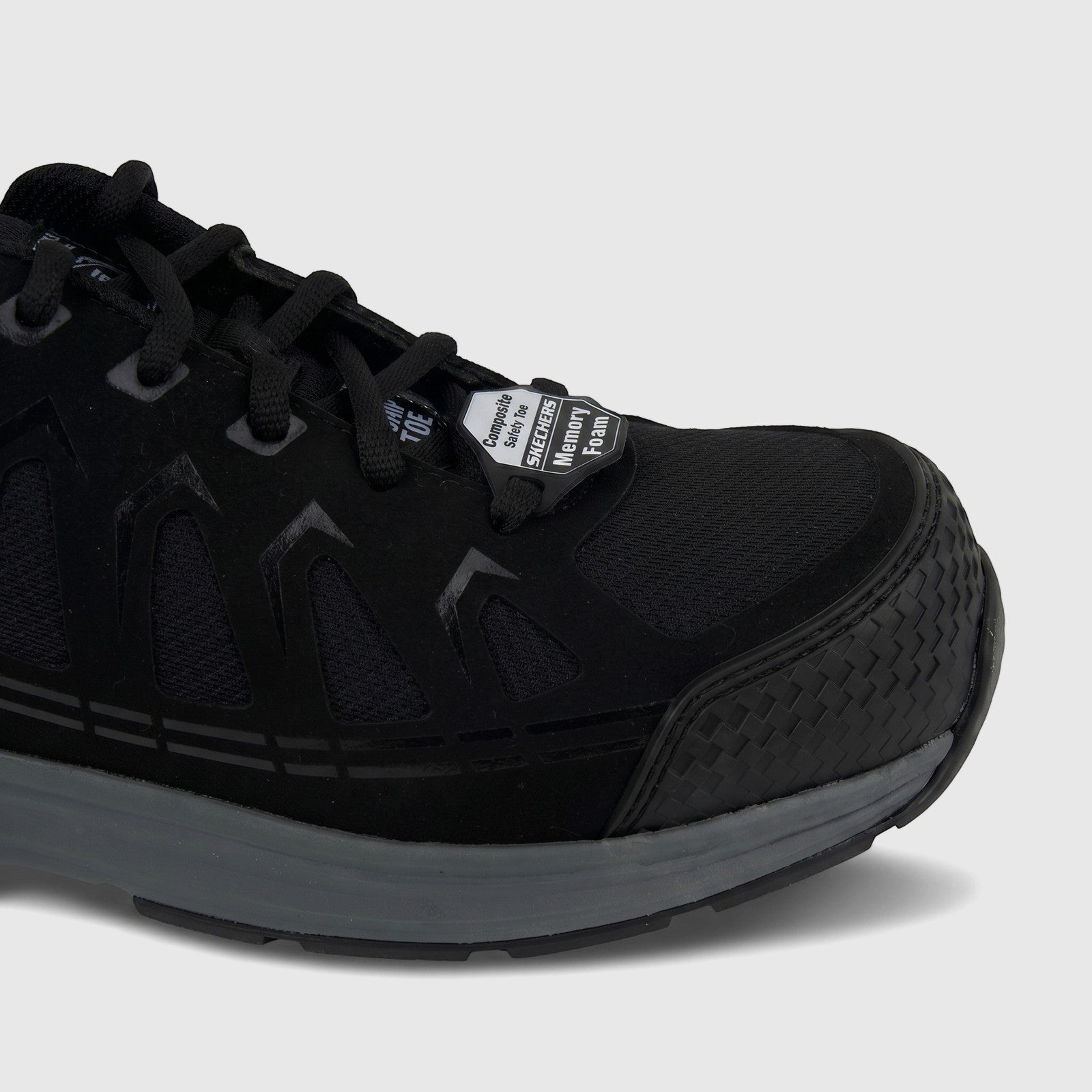 Black Skechers Men's Composite Toe safety sneaker, side view, featuring a durable mesh and synthetic upper with a grey sole.