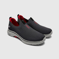 Pair of Skechers Men's Go Walk 7 slip-on sneakers in charcoal black with red accents, viewed from the side.