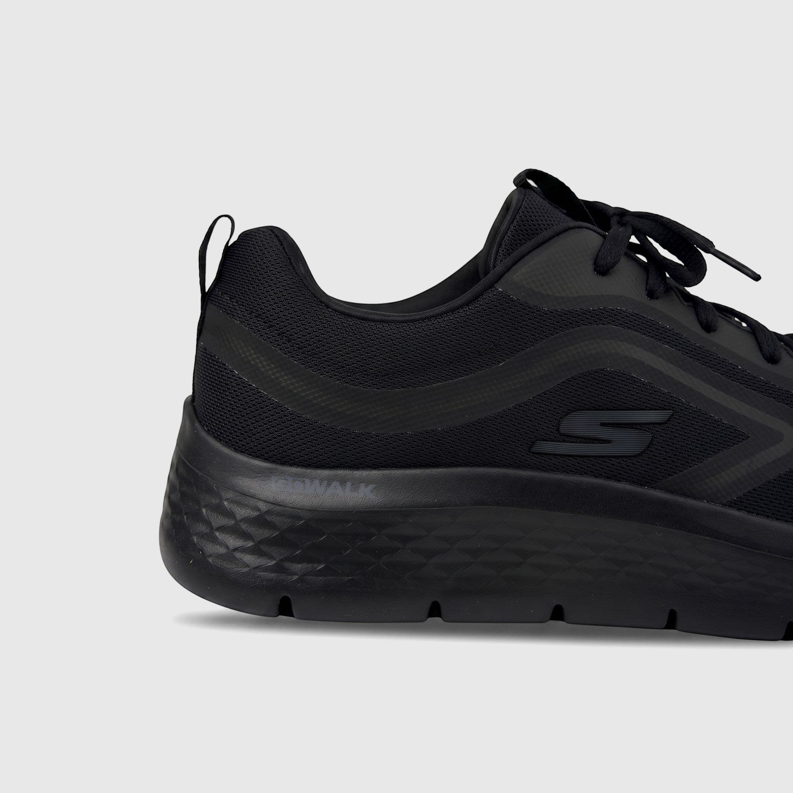 Black Skechers Men's Go Walk Flex comfort sneaker, side view showing the mesh upper, S logo, and textured sole.