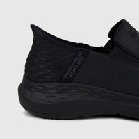 Skechers Men's Parson 204866 black slip-on comfort shoe. Side view, showing 'Skechers Slip-ins' branding, textured heel, and