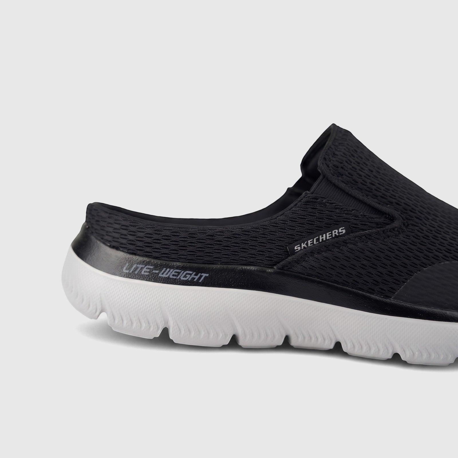 Close-up of a men's black Skechers Summits Vindicator slip-on comfort shoe with mesh upper and white lightweight sole.
