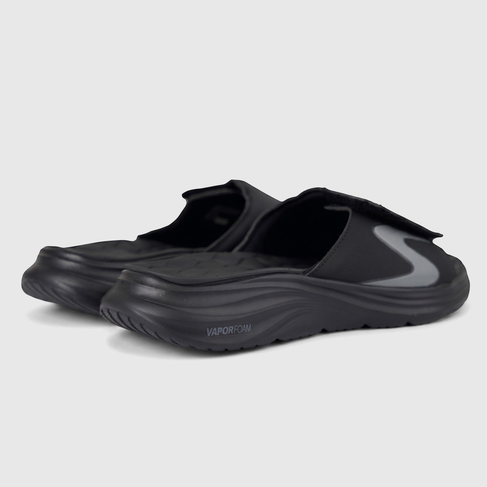 Pair of black Skechers men's Vapor Foam slide sandals with an adjustable strap and a prominent grey 'S' logo, offering