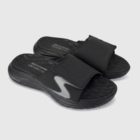 Pair of black Skechers Vapor Foam slide sandals with a gray S-logo and textured footbed on a clean background.