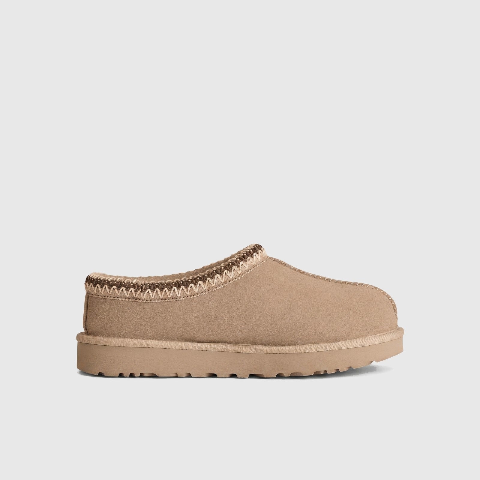 Ugg Ladies Clog Tasman II Moonlight slip-on clog in light beige suede with braided collar trim, side view