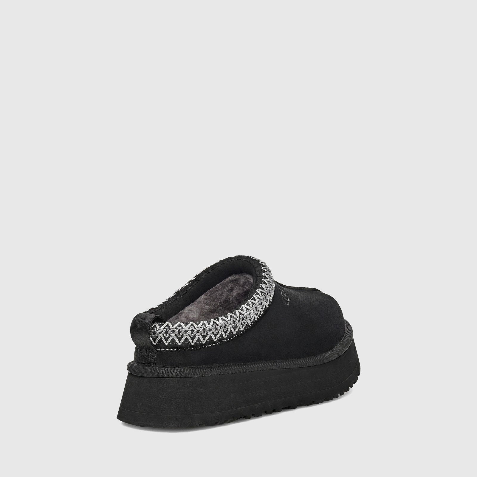 UGG Ladies Tazz II clog in black suede with plush lining and braided collar trim, shown from rear side view.