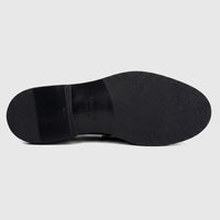 Valentino men's black leather slip-on shoe featuring a chunky sole, shown from the bottom revealing the textured outsole.
