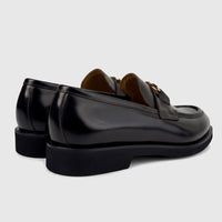 Valentino Men's Black Leather Chunky Sole Slip-On Shoes, featuring gold buckles and visible stitching, viewed from a