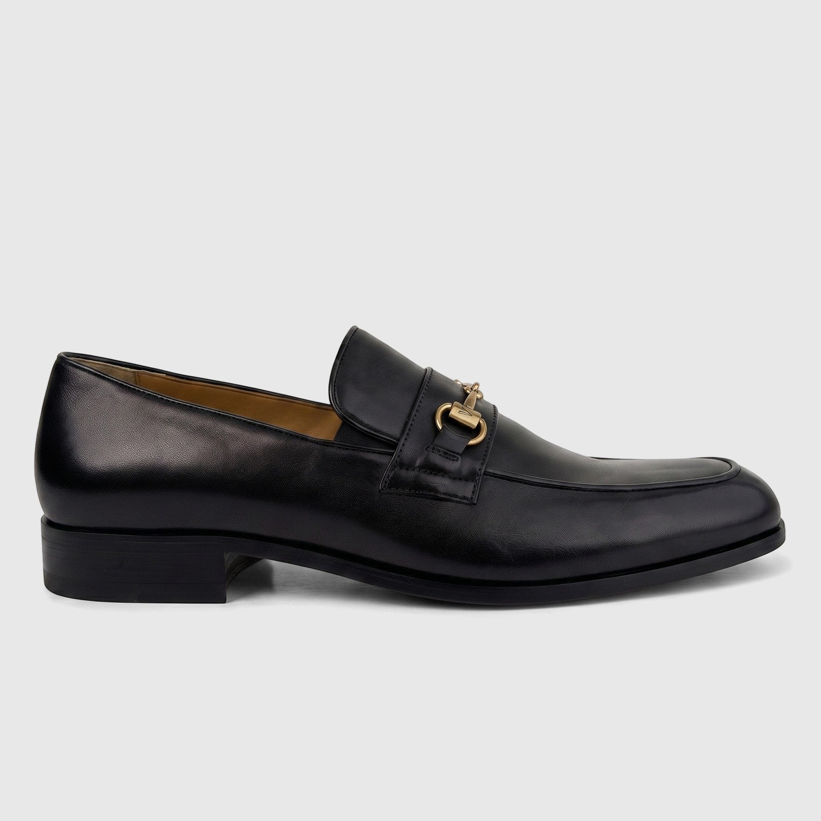 Valentino Men's Black Leather Dress Slip-On Loafer with gold-tone metal bit buckle hardware, shown in a side view.