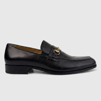 Valentino Men's Black Leather Dress Slip-On Loafer with gold-tone metal bit buckle hardware, shown in a side view.