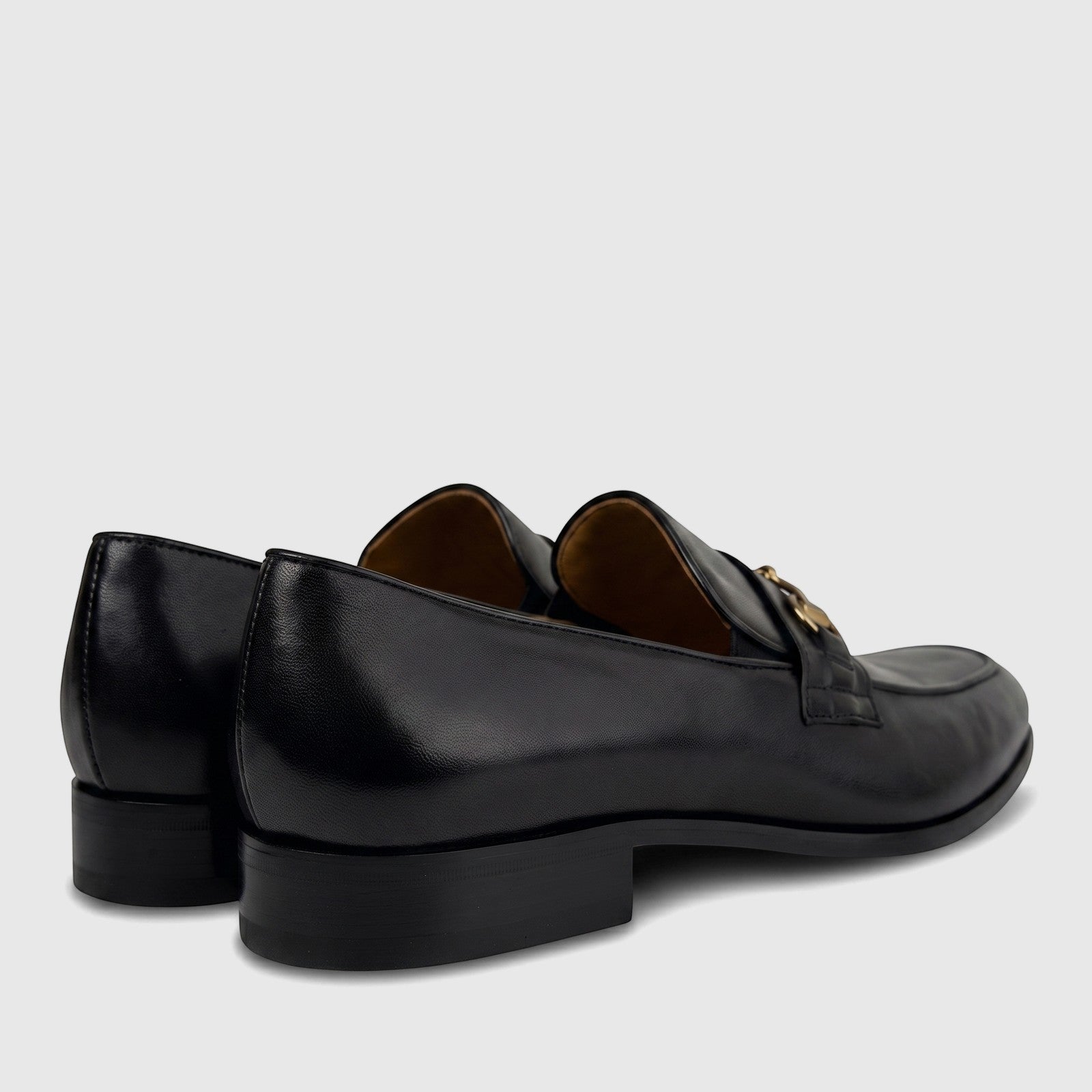 Valentino Men's Black Leather Dress Slip On shoes, detailed side and rear view, featuring a polished gold buckle on the