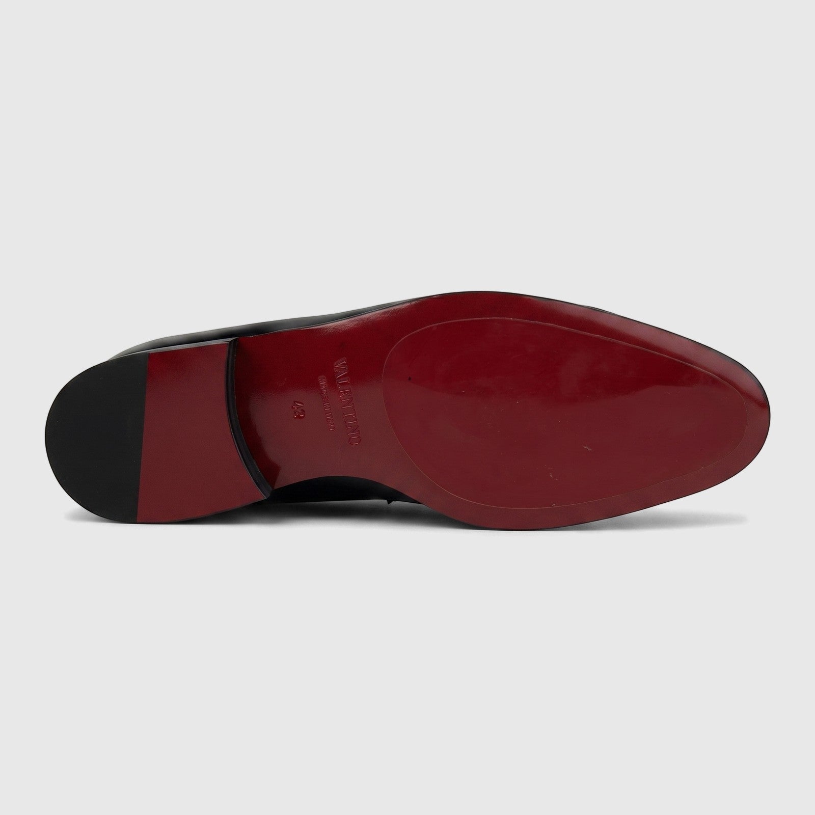 Valentino Men's Black Patent Leather Dress Slip-On shoe, viewed from the bottom showing the distinctive red sole.