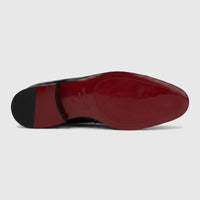 Valentino Men's Black Patent Leather Dress Slip-On shoe, viewed from the bottom showing the distinctive red sole.