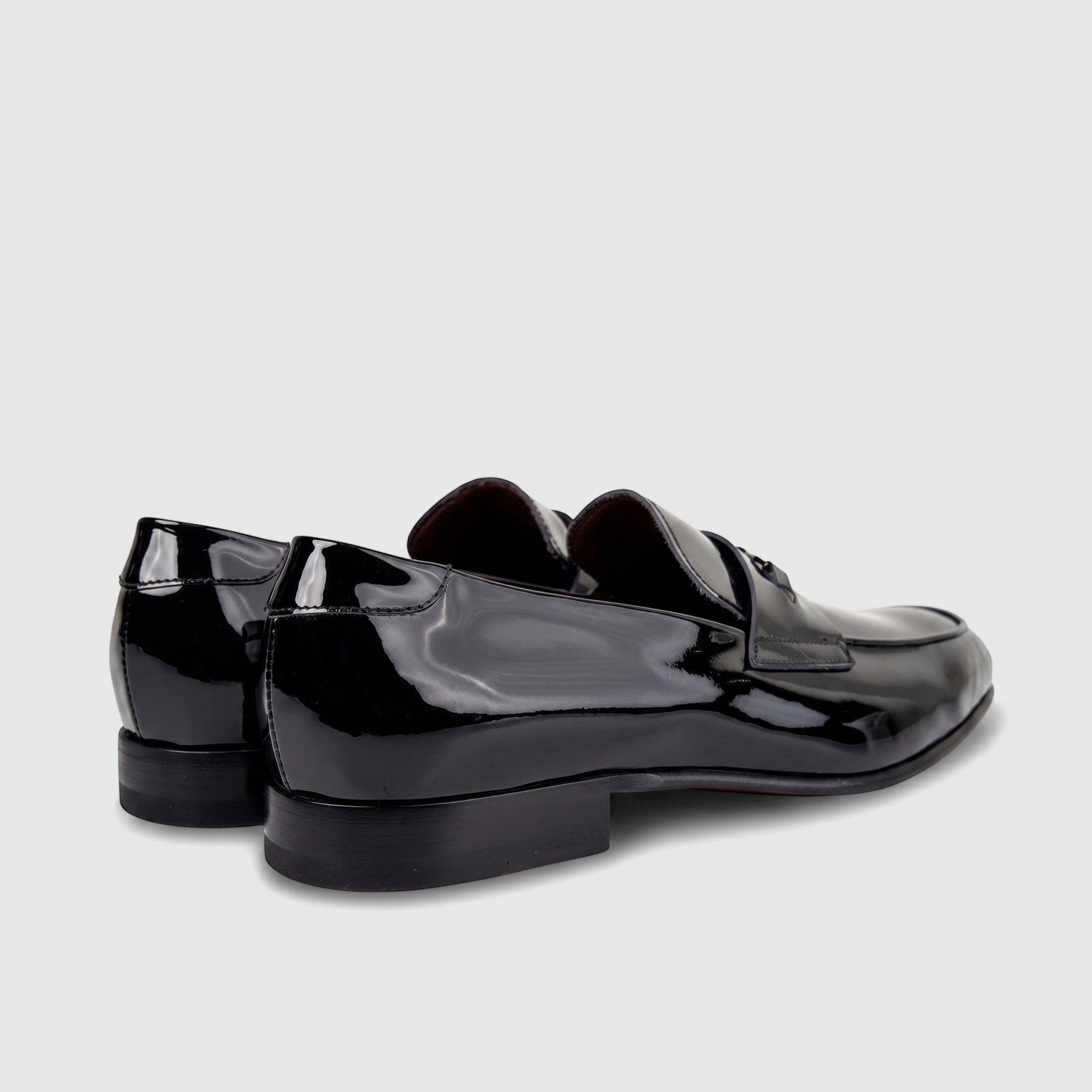 Valentino men's black patent leather dress slip-on shoes. View highlights the glossy finish and classic loafer design.