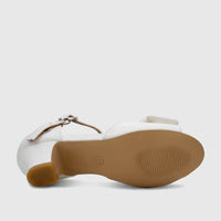 White girls' dress heel with a block heel and buckle strap, shown from the bottom-side view to highlight the sole.